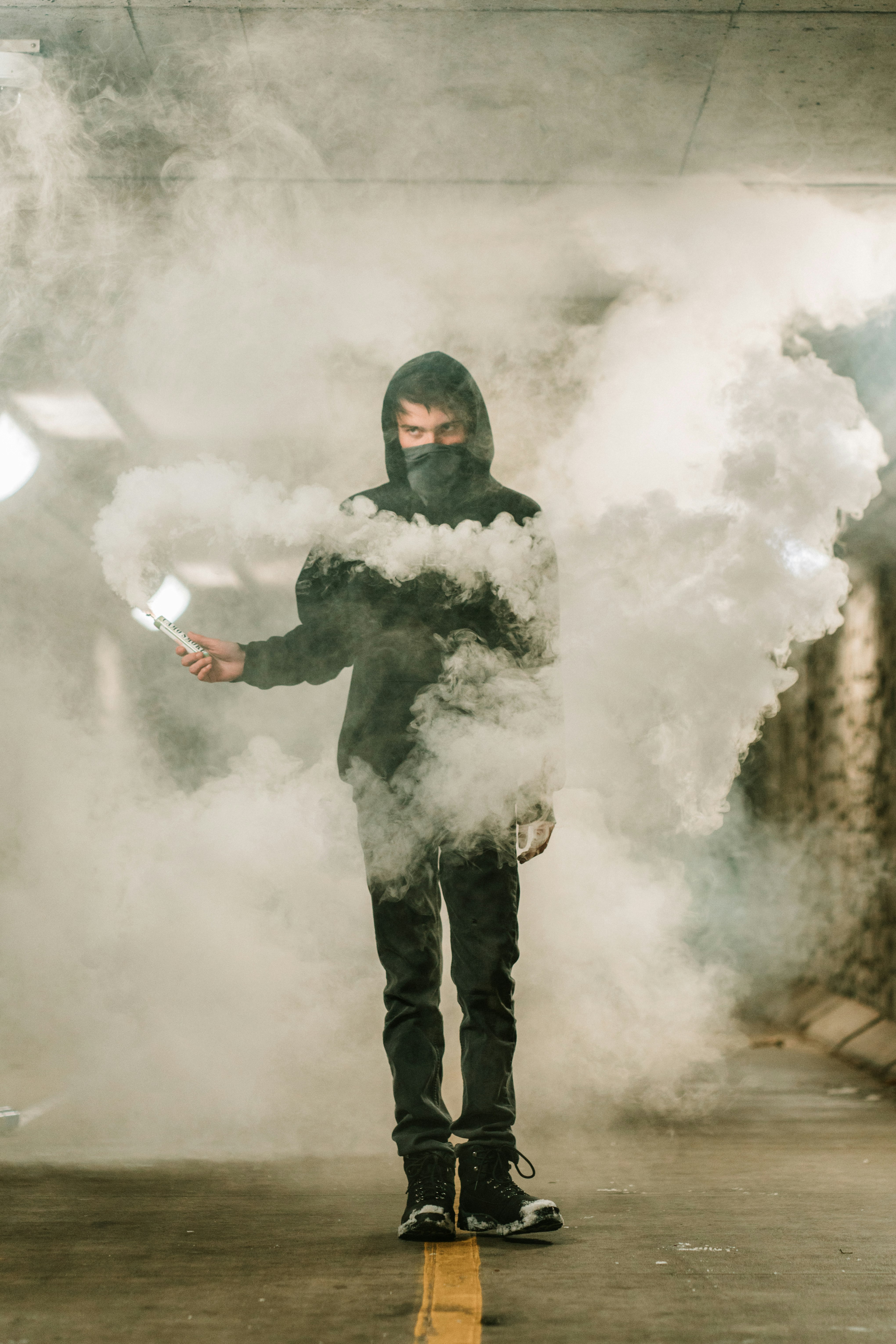 man in black jacket and black pants standing on white clouds